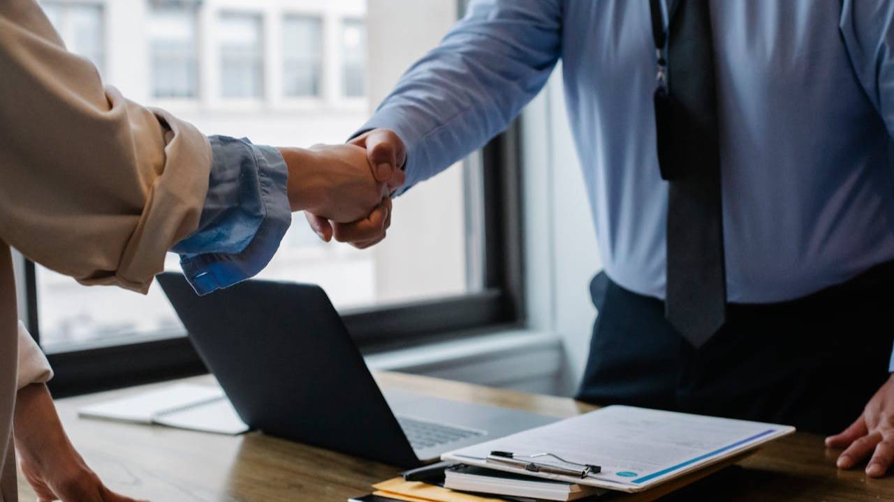 Image of two people shaking hands